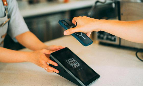 a close up shot of a person scanning a qr code